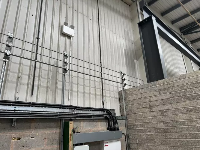 Part of the new pipework infrastructure installed at the Tamworth facility. This section shows three stacked pipework runs routed through the building &mdash; two high-pressure lines supplying the wash bay and one low-pressure feed serving the pressure washin